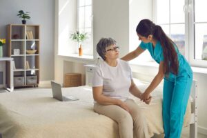 A small group of seniors participating in a gentle seated exercise class with a facilitator.
